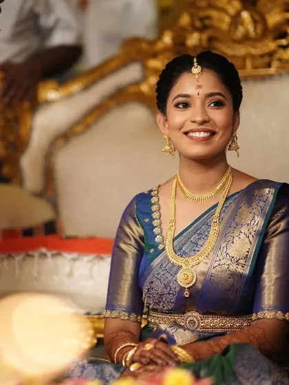 A beautiful, smiling portrait of the bride during her ceremony. The makeup enhances her natural beauty and looks flawless even in the bright event lighting.