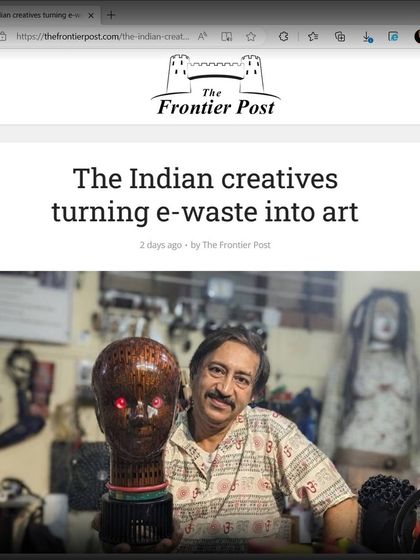 A screenshot of "The Frontier Post" article, "The Indian creatives turning e-waste into art," featuring a photo of me with one of my early bust sculptures.