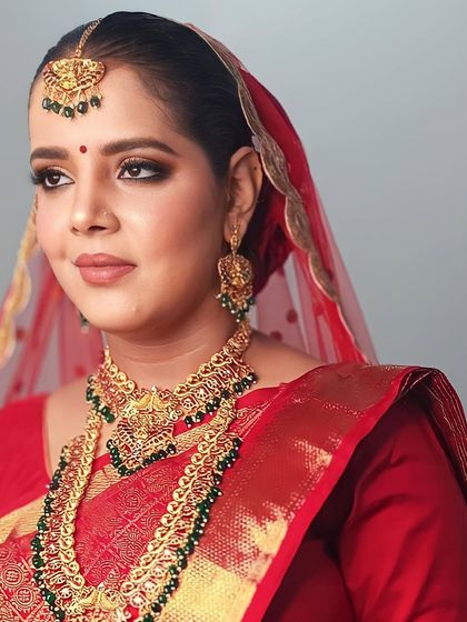A side profile of this beautiful bride, showcasing her temple jewelry and the flawless finish of her makeup.
