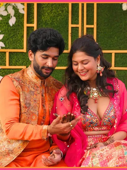 The groom admiring the bride's henna at their 'Satrangi' Mehendi. A sweet, candid moment.