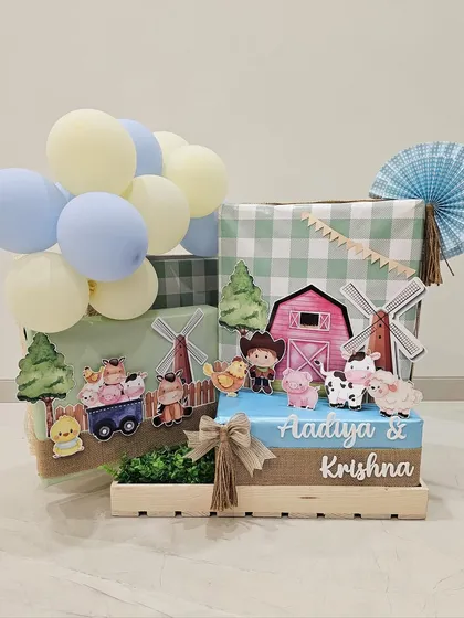 Bringing the cutest barnyard to life for a birthday celebration. This super adorable hamper, made for Aadiya and Krishna Piramal, features farm animal cutouts, gingham prints, and playful balloons.