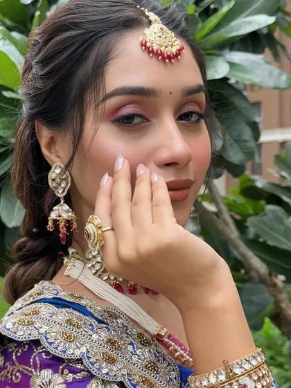 A close-up on the eye makeup, showing a beautiful blend of pink and brown shades that make the eyes pop.