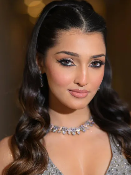 A direct portrait shot that shows the power of a well-executed glam look. The eyes are the focus, with sharp liner and bright, open whites.