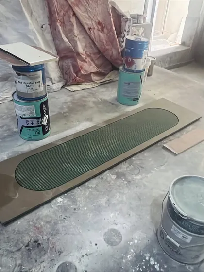 Another shot of the fluted panel, surrounded by paint cans in our workshop. This behind-the-scenes view shows the hands-on environment where our custom pieces are created.