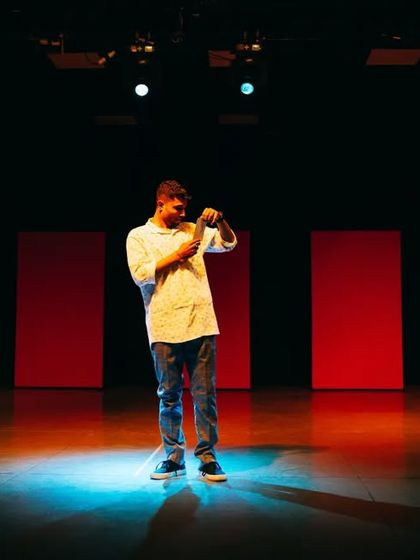 A solo performer commanding the stage with a single spotlight. This is the level of performance quality and confidence I aim to instill in every student.