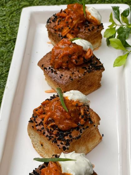 Butter chicken on toast. We've taken the beloved curry and transformed it into a chic open-faced sandwich, topped with a dollop of cream for that authentic, rich flavor.