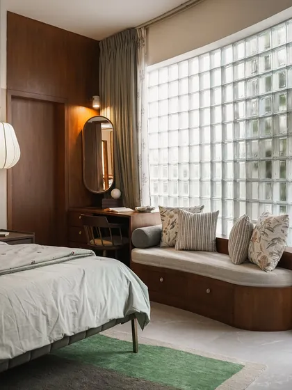 A bedroom should be a retreat. I used a wall of glass blocks to bring in soft, diffused light while maintaining privacy, creating a calm aura for this cozy window seat and study nook.