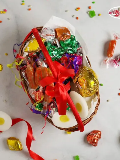 A festive Easter basket overflowing with our wrapped candies and chocolates. It also features our special marzipan eggs that look just like real boiled eggs.
