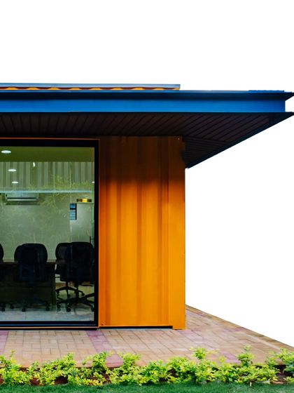 A close-up of the exterior of the Prestige container office. This shot highlights the clean lines and material combination of corrugated steel and sleek roofing that define its modern industrial aesthetic.