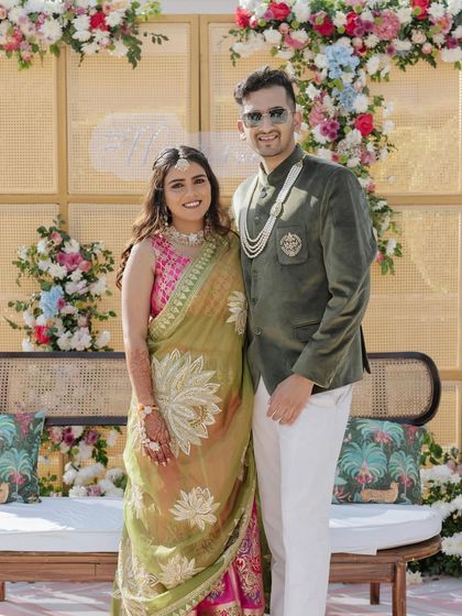 A beautiful portrait of the couple at their pastel Mehendi, with the elegant floral and rattan backdrop creating a soft and romantic setting.
