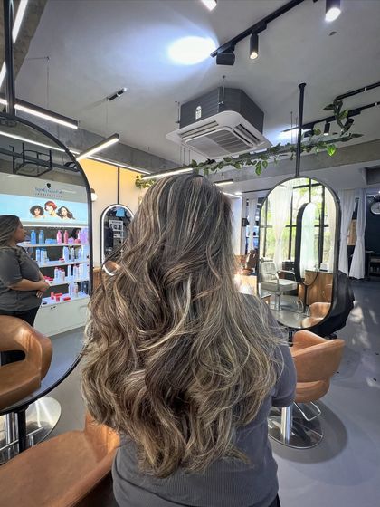 This lived-in color on long hair shows how balayage can create beautiful dimension. The mix of ash and blonde tones on a brown base is a popular request.