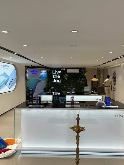 Another view of a finished Vivo store, showing the main counter and a green wall feature in the background. We often incorporate biophilic elements to make commercial spaces feel more inviting.
