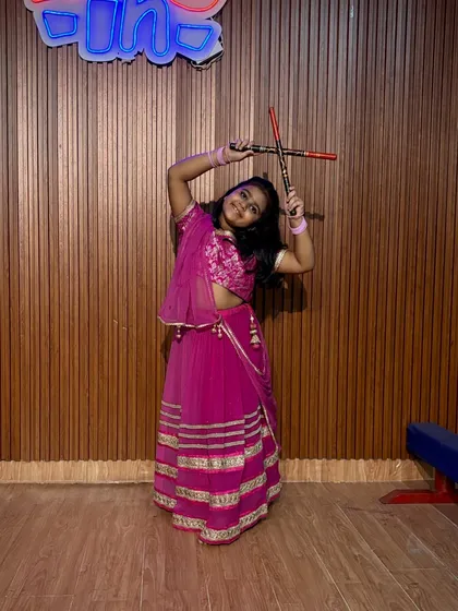 This student strikes a dynamic pose in her bright pink ghagra choli. The energy and enthusiasm of our young dancers are truly infectious.