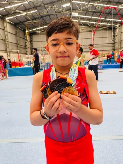 A handful of victory. Saurvik Khanna proudly displays the gold, silver, and bronze medals he won at the competition.