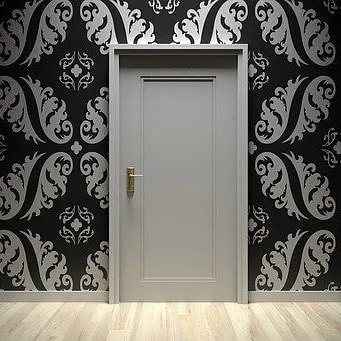 A bold statement for an entryway or feature wall using a high-contrast damask stencil. The sharp silver pattern on a black background delivers a dramatic and elegant look, showcasing our precision stencil painting services.