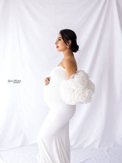 A classic profile shot is a must-have in any maternity gallery. It beautifully highlights the baby bump and the elegant lines of the gown, creating a timeless and graceful image.