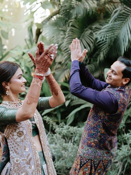 Pure happiness. This candid shot of the couple playing a game captures the fun spirit of pre-wedding events. The bride's makeup is designed to be long-lasting and photo-ready, even during the most energetic moments.