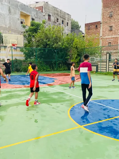 A player passes the ball after a rainy session.