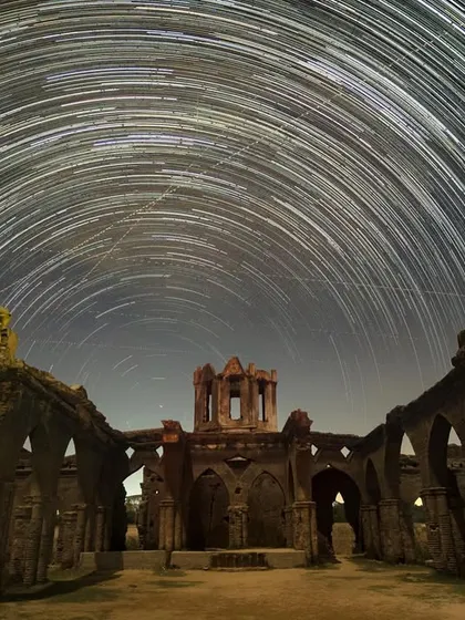 Star trails circle over the hauntingly beautiful ruins of the Shettihalli Rosary Church. This single image, a composite of many long exposures, captures the passage of time against a backdrop of history.