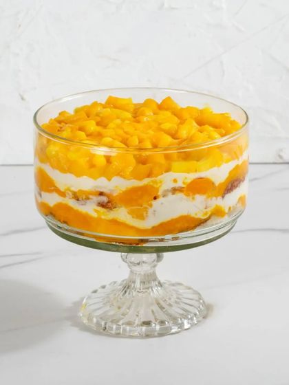 A single serving of my Mango Cream Cheese Trifle, with its vibrant layers of yellow mango and white cream.