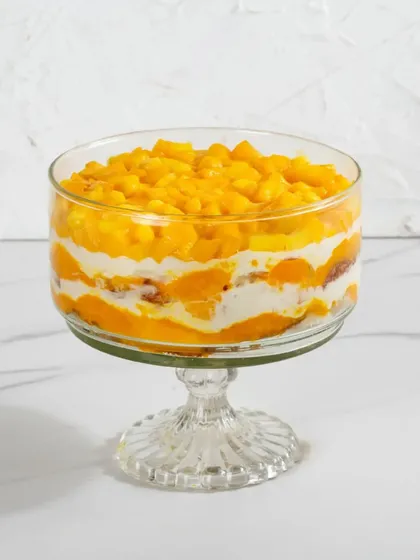 A single serving of my Mango Cream Cheese Trifle, with its vibrant layers of yellow mango and white cream.