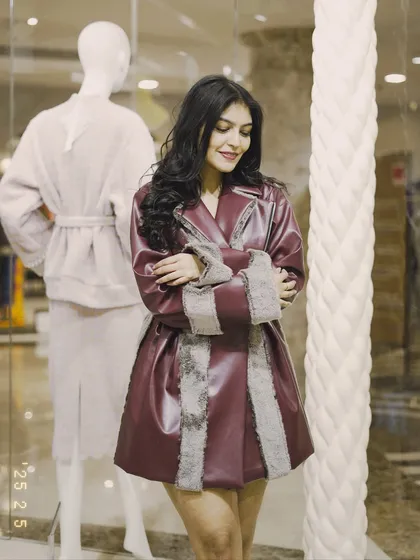 Another shot of the burgundy coat. The fit and flare silhouette is very flattering and adds a touch of drama.