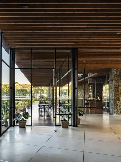 The open-plan design of the Radisson Resort's public areas allows for uninterrupted views and a natural flow of movement, connecting the restaurant, lounge, and outdoor terraces.