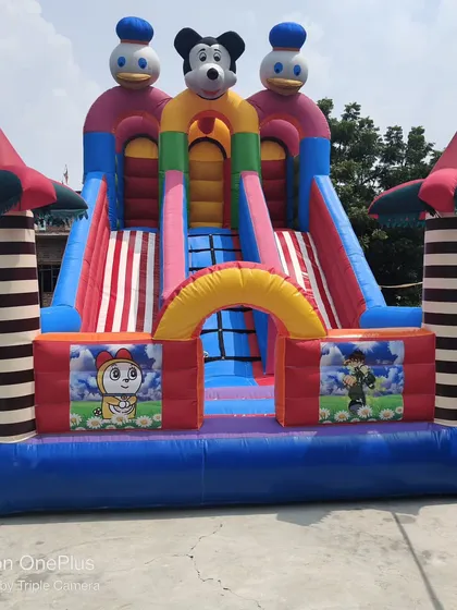A 12x18 foot 3-slider bouncy with striped slide lanes and pillars. The heavy-duty construction is visible in the reinforced seams and sturdy structure.