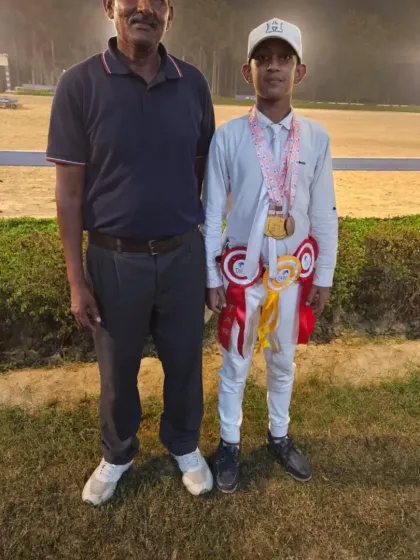 One of our champion riders with his coach, proudly wearing his medals after a successful competition.