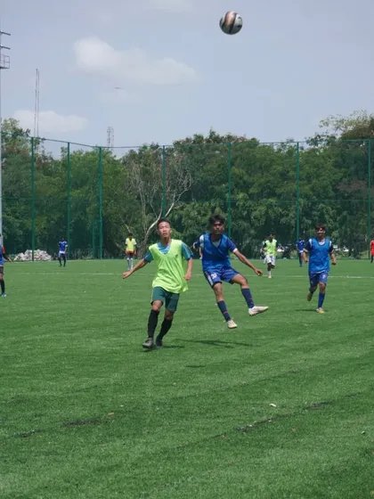 The competition is fierce at every age level. This shot from our U16 and U18 trials shows two players battling for an aerial ball, highlighting the intensity we look for.