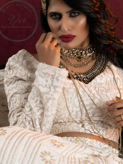 Glamour is the essence of self-assurance. This look is all about a fierce, confident energy, with a striking red lip and dramatic eye makeup.