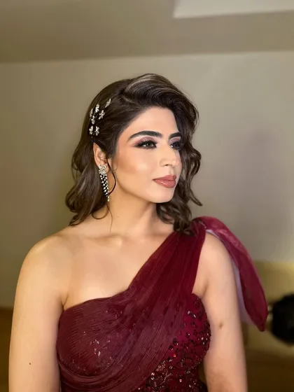 Creating timeless beauty for Jasleen's special day. Her reception look in a maroon gown was all about Hollywood glam with a bold eye and soft waves.