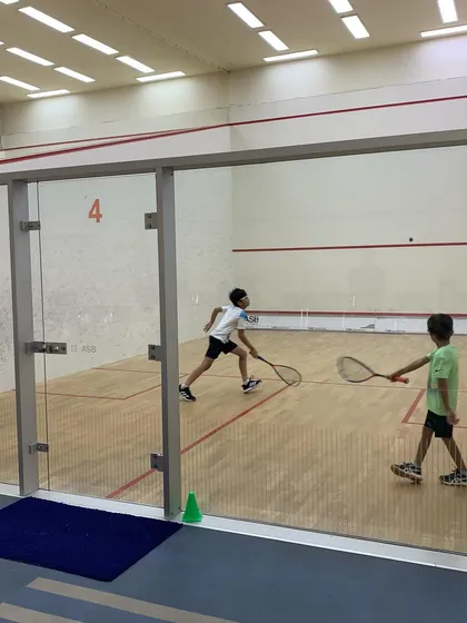 The competition was fierce at the Willingdon Squash Academy tournament. This shot captures the intensity of a match between two promising young players.