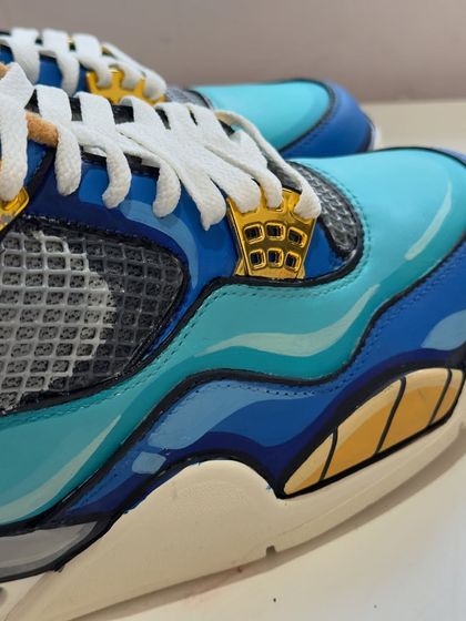 Another angle of the Vegeta custom Jordans, focusing on the clean lines and color blocking.