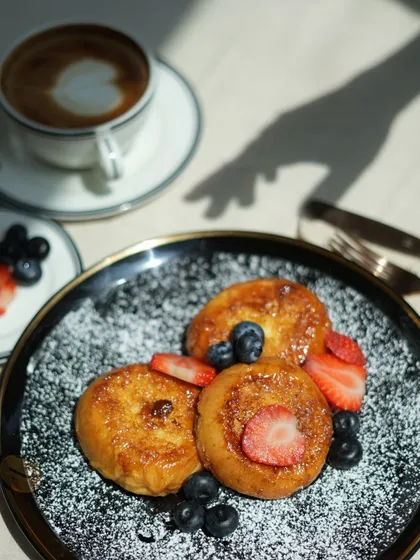 The morning light catching a plate of my French toast and a cup of coffee creates a picture-perfect moment that I love to offer my guests.