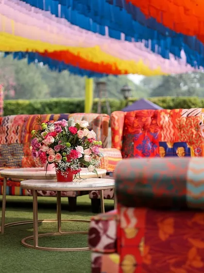 A seating area with quirky, colorful patchwork sofas, perfect for a vibrant Mehendi or Haldi.
