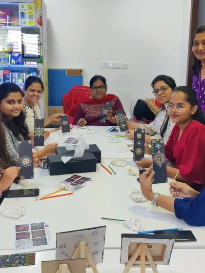 A group of professionals from Colliers taking a creative break with a dot painting workshop in their office. This demonstrates how my art sessions can be adapted for corporate wellness events, offering a relaxing and team-building activity.