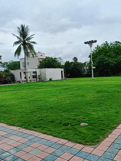 A wide, open lawn area in the park, perfect for community activities.