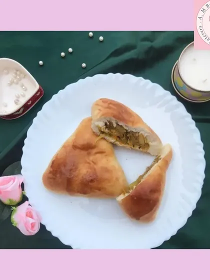 A closer look at my popular aaloo bun, cut open to show the generous spiced potato filling inside. The bun is soft and freshly baked, making it a perfect savory snack.