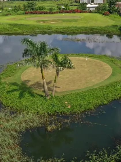 Welcome to our slice of paradise in Karjat. This aerial view showcases one of our signature water hazards, an island green that challenges your accuracy while offering stunning scenery.