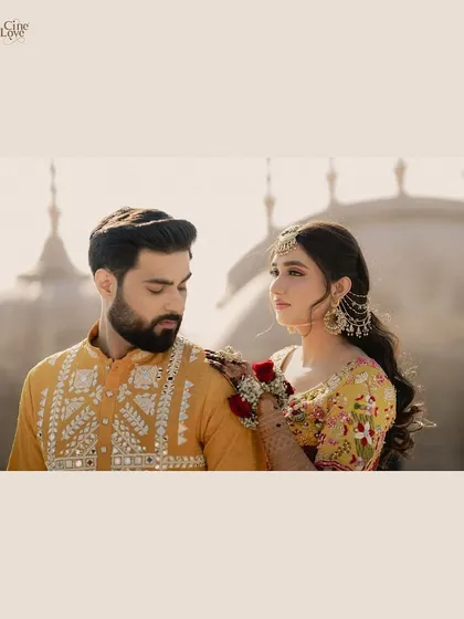 A beautifully framed shot of the couple against the domes of the Fairmont Jaipur, capturing a moment of quiet connection.