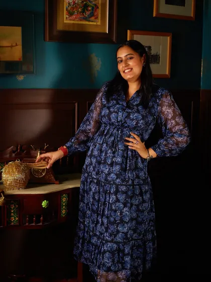 A candid moment of me on set, caught by the photographer. I was checking the lighting and setup, but it turned into a great shot that captures the beautiful vintage aesthetic of the location.