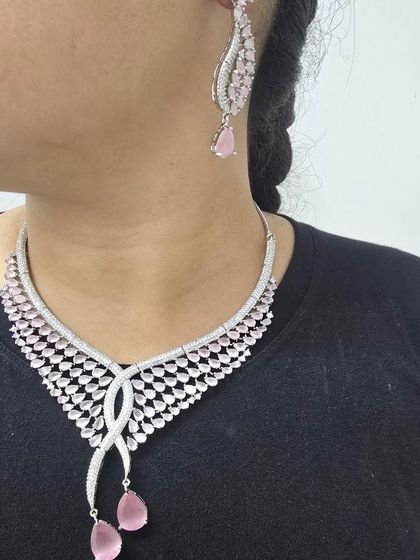 A beautiful pink American Diamond necklace set. The delicate design and soft color make it a great choice for an elegant evening look.