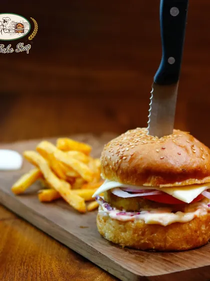 Beyond the sweets, we also craft delicious savoury options like this hearty Veg Burger. Served on our freshly baked bun with a side of fries, it's a satisfying meal for any time of day.