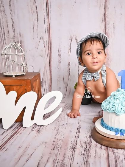A sweet look for the camera before the smashing continues. This little boy's first birthday portraits are full of charm and personality.