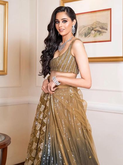 A three-quarter view of the ombre lehenga, showing the beautiful movement of the skirt and the elegant makeup.