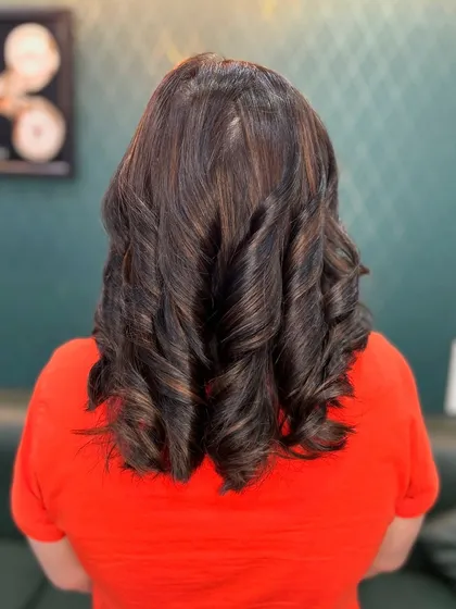A slightly different angle of these classic brown curls. The colour looks rich and deep, and the styling is perfect for a formal event or special occasion.