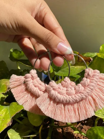 A close-up of our handmade boho fringe earrings. You can see the detail in the knots and the soft fringe, all crafted by hand to create a beautiful piece of jewelry.