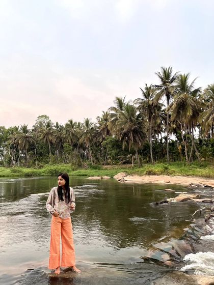 Another perspective of the river scene, showing the gentle rapids and the lush greenery on the banks.