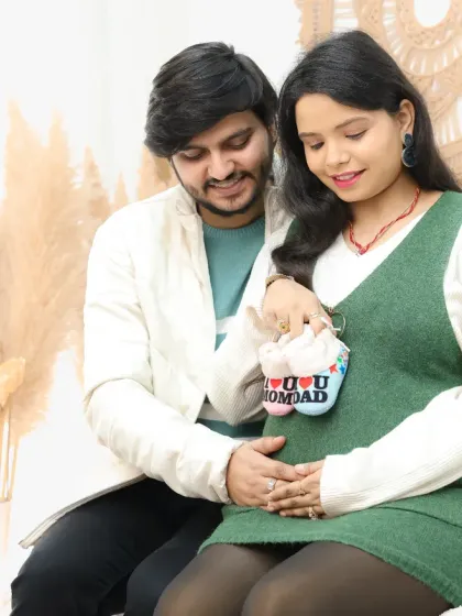 Tiny baby shoes are a perfect prop to symbolize the little one on the way. This pose is a classic way for couples to share their excitement during a maternity session.